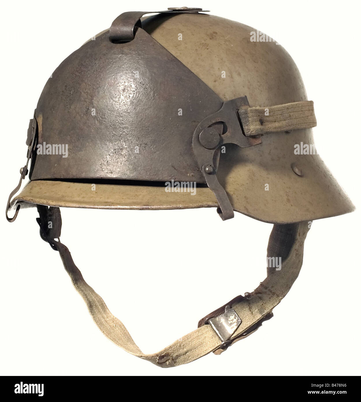 A Berndorf type steel helmet with a supplementary front shield.,  Dirt-brown, lacquered steel bowl with the rim turned under and four  ventilation holes on top covered by a flat steel plate. Fabric