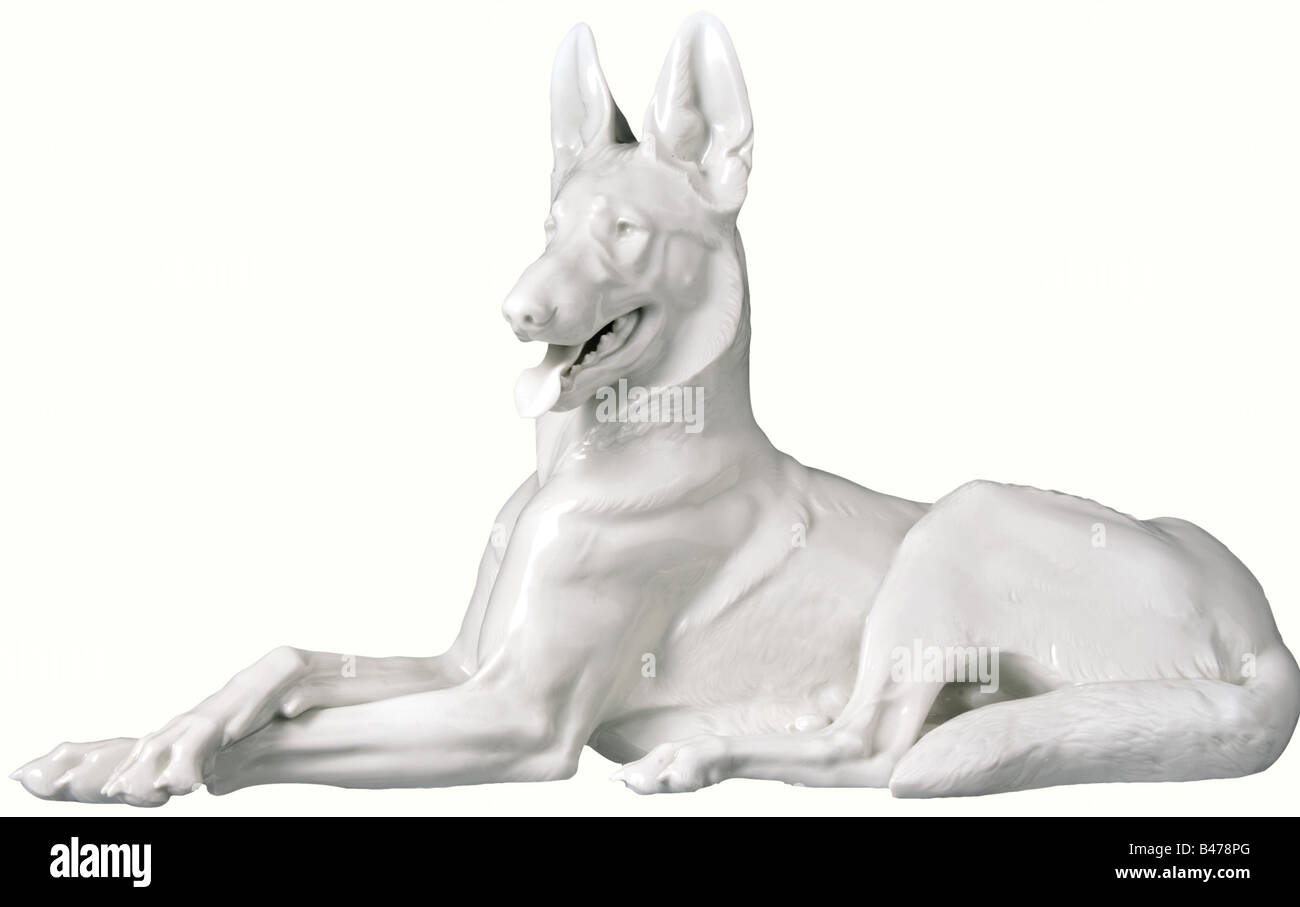 A large recumbent Alsatian dog., White glazed porcelain with the manufacturer's mark 'SS Allach' in an octagon on the bottom with the signature 'Th. Kärner' and the serial number '76' stamped above it. Height 25.5 cm, length 43.5 cm. fine arts, 1930s, 1930s, 20th century, object, objects, stills, clipping, clippings, cut out, cut-out, cut-outs, Additional-Rights-Clearance-Info-Not-Available Stock Photo