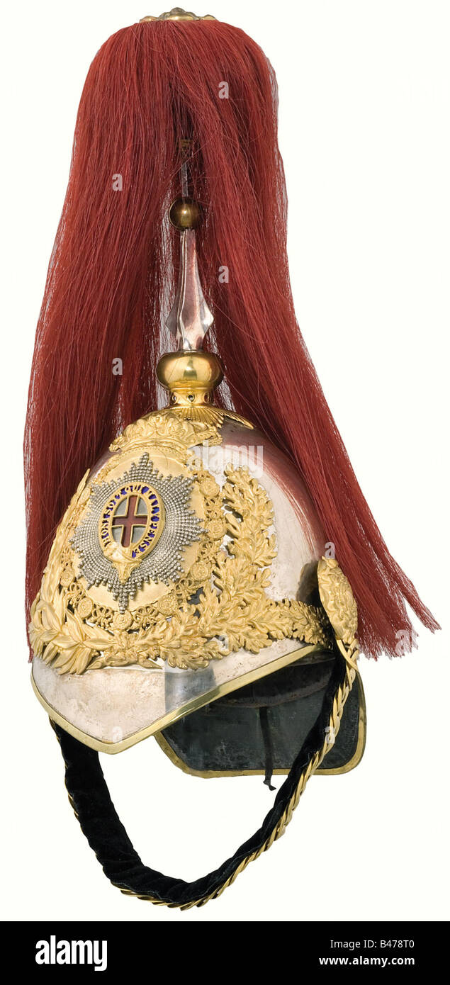 A helmet for officers of the Horse Guards, 19th/20th century. Two-piece tombac skull, gold plated mountings, enamelled plate with the Star of the Order of the Garter. Red falling horsehair plume (attachment nut missing). Velvet backed metal chinscales on Tudor roses. Brown fabric lining with marks of wear. The front and rear peaks are lined with leather. Size 56. In a metal storing box with the owner's name plate riveted onto it. External rust. historic, historical, 19th century, object, objects, stills, clipping, clippings, cut out, cut-out, cut-outs, helmet, , Stock Photo