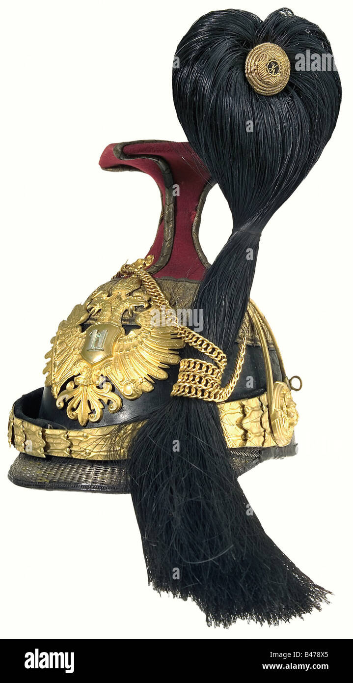 A czapka for subalterns, (Lieutenant/1st Lieutenant) of the Uhlan Regiment No. 11. Red cover, gilt fittings, chin chain consists of combined links, emblem with attached '11', black horsehair plume, gilt chain on lion's head mounts, golden border with two black interlaces. White silk liner with maker's stamp of the Court Supplier 'M. Wolf, Wien' as well as a name's stamp, brown leather sweatband. historic, historical, 19th century, Imperial, Austria, Austrian, Danube Monarchy, Empire, object, objects, stills, clipping, clippings, cut out, cut-out, cut-outs, unif, Stock Photo