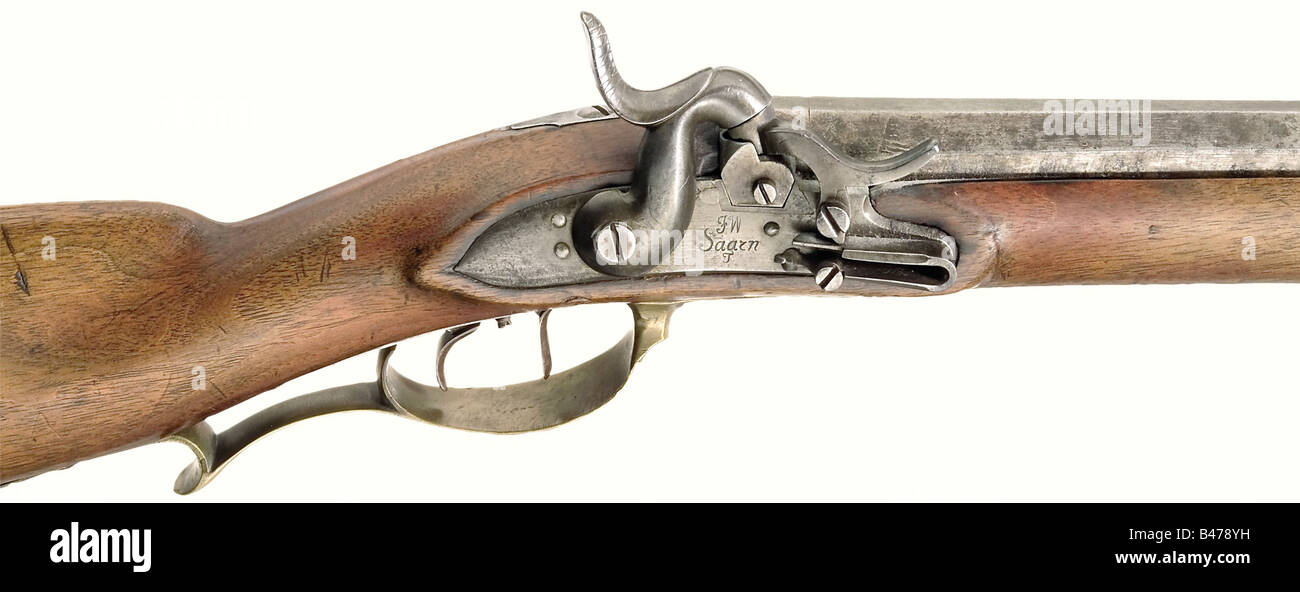 A model 1810/35 Jäger rifle., Octagonal barrel with seven groove rifling in 15 mm calibre. Dovetailed fixed rear sight with two folding leaves. Converted lock with a hinged nipple protector. Lock plate has the maker's mark, 'Saarn' as well as 'FW'. Set trigger. Walnut stock with brass furniture, and patch box. Bayonet mounting on the side removed by a military armorer. Iron ramrod with brass jag. Length 105 cm. Extremely rare. Only 1113 rifles were made in Saarn between 1810 and 1835. historic, historical, 19th century, Prussian, Prussia, German, Germany, milit, Stock Photo