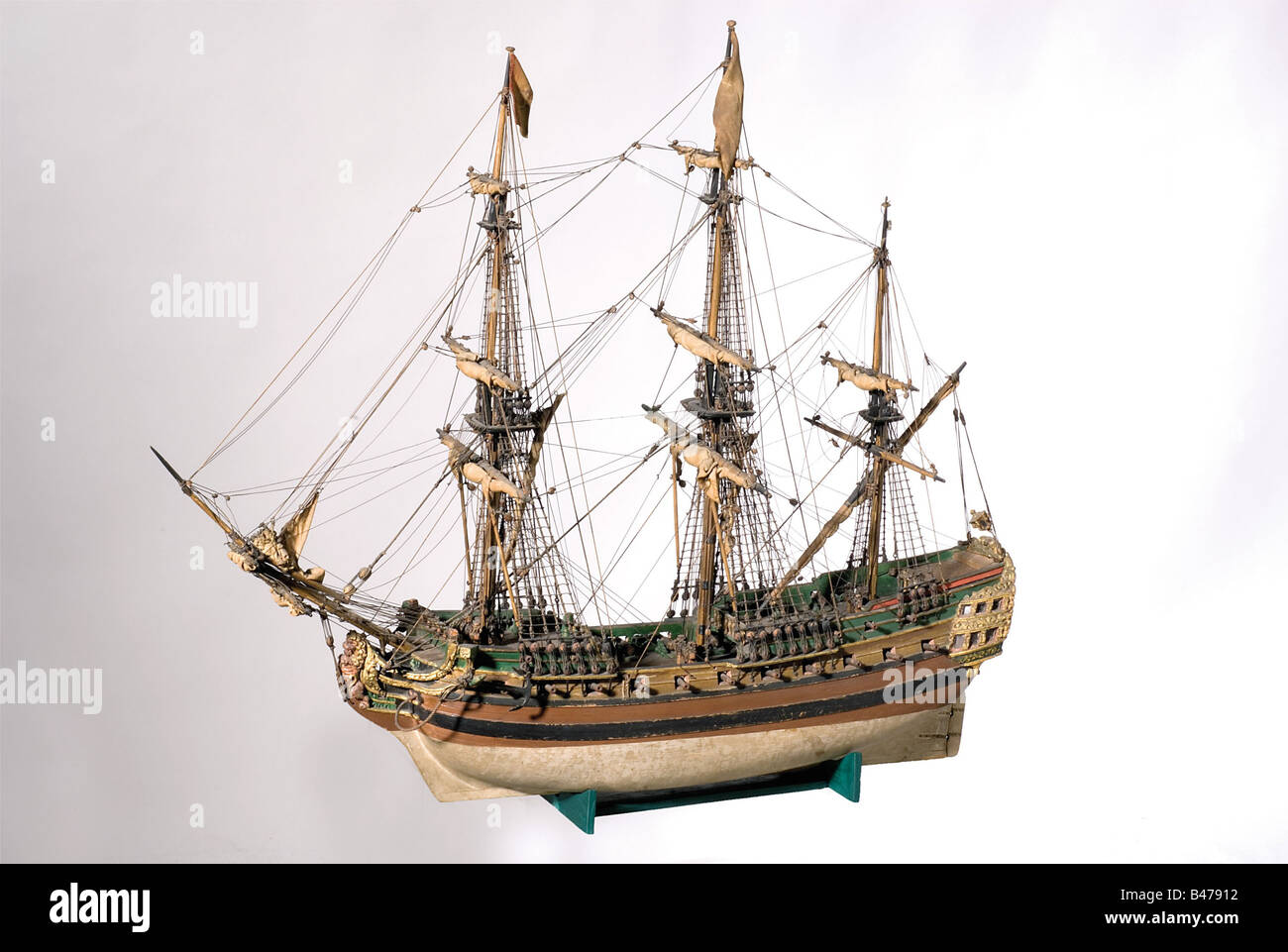 A wooden model of the frigate 'D'Mercuur'., Hand made, extremely detailed model of a frigate of the first half of the 18th century. Fully rigged masts with reefed sails. Painted in colour and gilded, the windows in the stern cabin are completely glazed. Length 69 cm. Width 30 cm. Height 59 cm. Very decorative and historical,ly accurate model of a ship from the sea wars between Holland and England. historic, historical, 18th century, object, objects, stills, clipping, clippings, cut out, cut-out, cut-outs, miniatures, miniature, mini, model-making, modelmaking, , Stock Photo