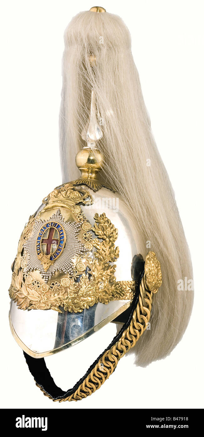 A helmet for officers of the Life Guards, 20th century. Nickel-silver skull with a seperately attached neck protector, gold plated mountings, enamelled emblem with the Star of the Order of the Garter. White falling horsehair plume (attachment nut missing). Velvet backed metal chinscales on Tudor roses. Red silk lining with slight marks of wear. The front and rear peaks are lined with green leather. Size 56. historic, historical object, objects, stills, clipping, clippings, cut out, cut-out, cut-outs, Stock Photo