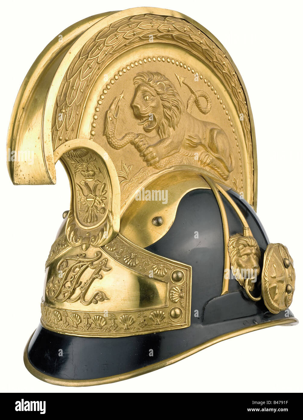A helmet for a cuirassier officer, circa 1848/1850. Skull is of zinc-plated sheet iron with exterior black lacquer, gilded furniture, and a crest with a lion partially covered with frosted gilt, partially polished. The front plate bears the cipher 'FJI' (only worn this way for two years, as in 1850 it was superceded by a different model helmet). Broad metal chinscales on lion's heads mounts. Leather lining and leather chin straps. A rare helmet in exemplary condition, but without the yellow-black wool crest. It comes with the leather carrying case with address , Stock Photo