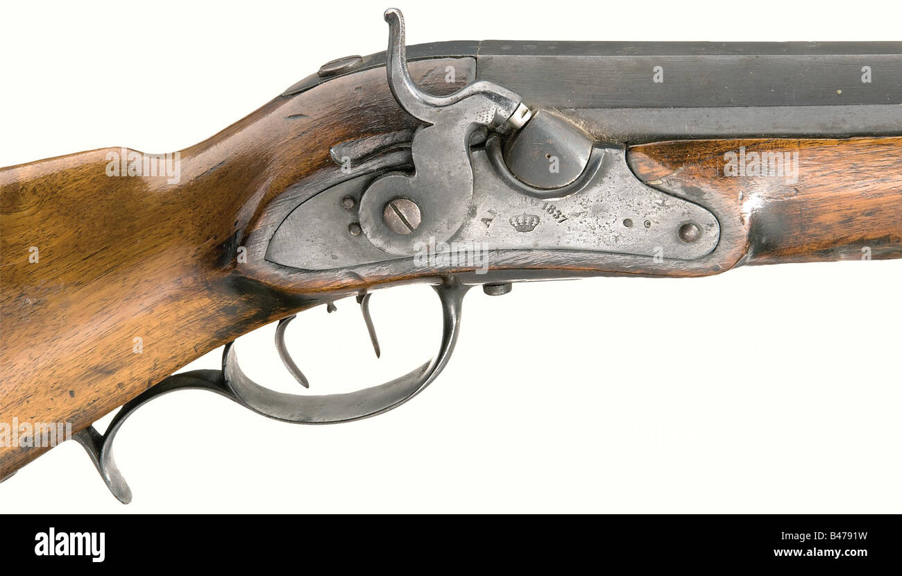 A wall rifle, model 1831, experimental version., Octagonal barrel merging to round with a seven groove rifled bore in 22 mm calibre. Dovetailed fixed sights. The marks 'GF', a crown, and 'C' are stamped on top of the breech. Percussion lock stamped 'Amberg 1837' with a crown. Double set trigger. Walnut half stock with iron furniture. Compartment in the buttstock contains three lead balls. The front end of the stock has a hole for the missing pivot trunnions. Barrel length 90.7 cm. Total length 128.5 cm. Hitherto unknown experimental model with altered barrel sh, Stock Photo