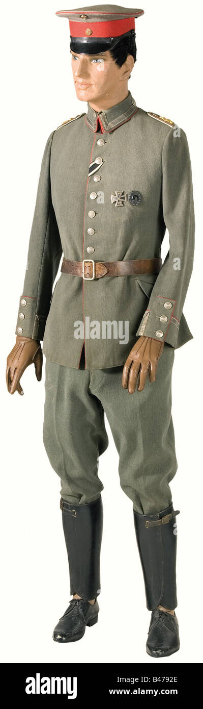 A field uniform, for a Warrant Officer (war time rank only) in the Hessian 116th Infantry Regiment. Service cap of field grey gabardine with red piping and lace, metal cockades, leather chin strap. Torn, moth damage. Field tunic model 15 of field grey cord with red piping, nickel plated crown and sergeant buttons, silver lace on the collar and sleeves, green silk lining, Iron Cross buttonhole ribbon, Iron Cross 1st Class and Wound Badge are pinned on. Interwoven silver and red shoulder boards with golden overlay and white backing are sewn on. Riding breeches of, Stock Photo