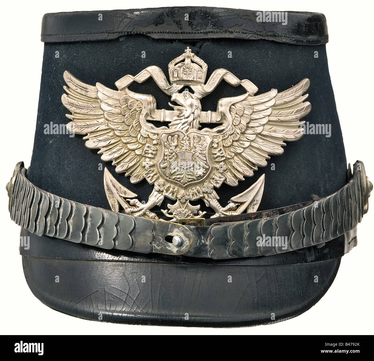 A shako with silver mountings for marine officers., Cloth covered leather body, peaks, lower band, and top are black lacquered (rear peak porous). Silver plated eagle plate and metal chinscales. Ventilation mesh on the sides. Field insignia missing. Champagne coloured ribbed silk lining. Leather sweatband. An old Shako with all the original pieces. Possibly belonging to an official, although normally they wore the general naval uniform. historic, historical, 1900s, 1910s, 20th century, navy, naval forces, military, militaria, branch of service, branches of serv, Stock Photo