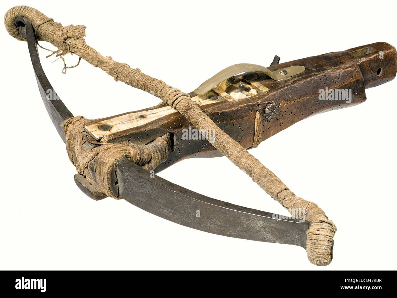 A crossbow, German, 17th century. Heavy, iron prod with smith mark stamped into one side (hunting horn). Fastened to the tiller by cord, old hemp bowstring. Walnut tiller (worm damage). The end has a mounting socket. Bone quarrel channel with a horn quarrel retainer. The nut is made of bone and lashed in place with cord. Iron trigger mechanism on the side for release by a trip wire. Length 45 cm. A rare type of crossbow, which was set at dens while hunting fox and badger, but especially used for securing buildings against unauthorized entrance. historic, histor, Stock Photo