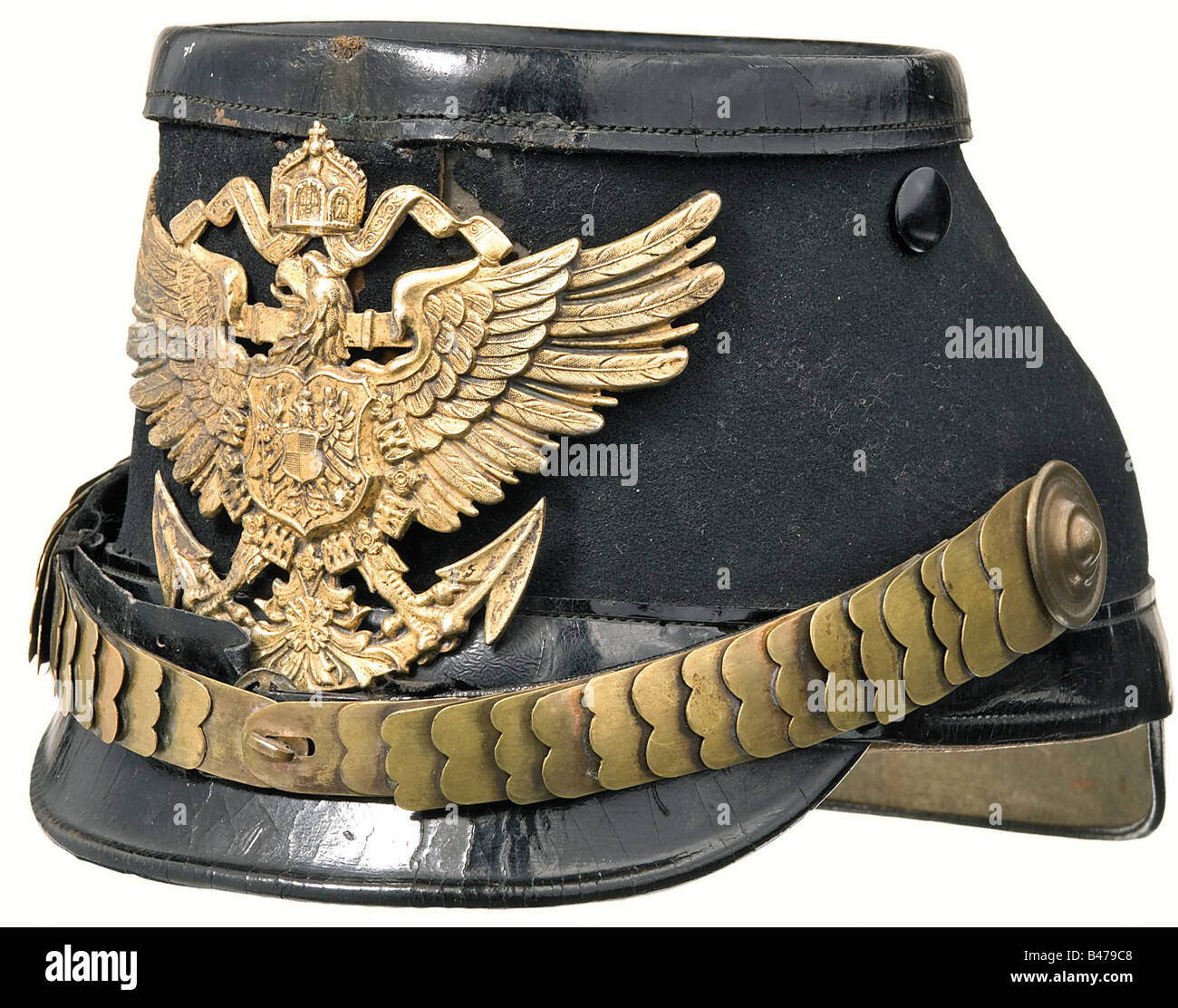 A shako for marine officers., Cloth covered leather body, peaks, lower leather band, and top are black lacquered. Gilded eagle plate and metal chinscales. Field insignia missing. Ventilation mesh replaced by post buttons. Leather sweatband. Lining missing. Name is hand written inside. historic, historical, 1900s, 1910s, 20th century, navy, naval forces, military, militaria, branch of service, branches of service, armed forces, armed service, object, objects, stills, clipping, clippings, cut out, cut-out, cut-outs, Stock Photo