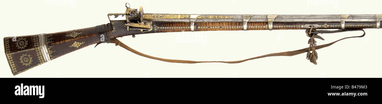 An Ottoman miquelet flintlock rifle, end of the 18th century. Octagonal,  lightly swamped barrel with seven groove rifling in 12 mm calibre, with  fixed aperture sights. Floral gold inlay and brass-filled maker's
