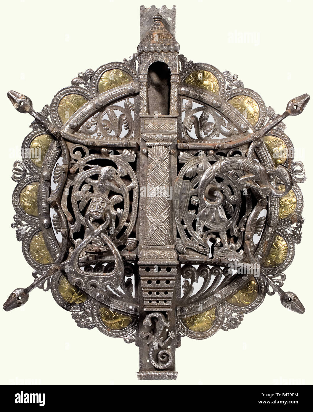 A large Viennese(?) gate lock, in the Roman style, circa 1900. Forged iron. Round, two-piece lock screen set with a rectangular lock case and a cover with decorative openwork figures. Narrow central raised section with an architectural top. Key missing. Handle is in the shape of a sculpted dragon. Movable tugging ring. Screen surrounded with inset embossed brass plates displaying evangelical symbols and fabulous animals. Richly chiselled ornamentation. Height 73 cm. historic, historical, 1900s, 20th century, 19th century, handicrafts, handcraft, craft, object, , Stock Photo