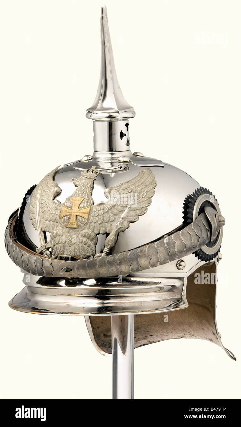 A reserve officer's helmet, for the Prussian Mounted Jäger Regiments 1 - 6 Late, elegant model from circa 1914. Nickel-plated steel bowl with nickel-plated or nickel silver mountings. The neck protector is of tombac with an attached ridge. The removable grooved spike (somewhat damaged) has a bayonet catch. Officers' cockades, non-standard silver (really gilded) convex metal chinscales of tombac, without the cloverleaf attachments. Brim and neck protector are leather lined (somewhat spotted). Leather sweatband (handwritten inscription, 'Fähnrich Jäger z. Pferd R, Stock Photo