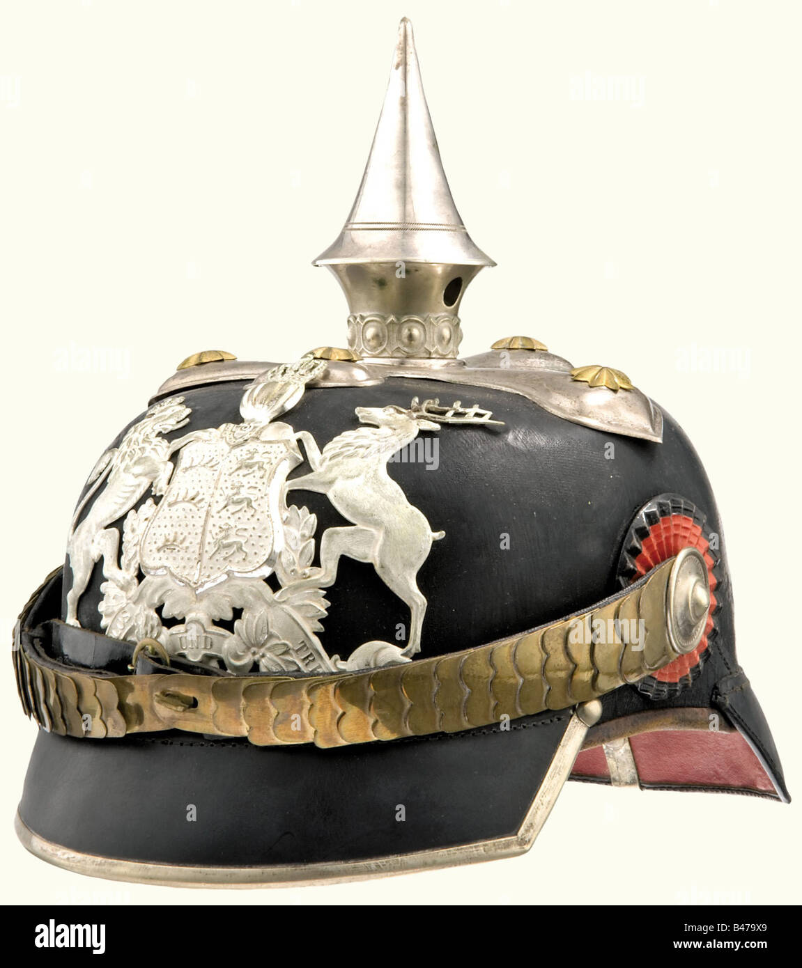 A helmet, waist belt and bowler hat, for a Captain of the Grenadier Regiment Queen Olga (1st Württemberg), No. 119 Stuttgart. An officer's helmet, with a black leather skull, silver mountings, a cross base with a small golden star, silvered, frosted front-plate with partially polished edges. Flat golden metal chinscales. Angular, silver trimmed visor, both cockades. Ribbed silk lining loose in places. Size 57. An officer's waist belt, silver weave with two black/red interweavings. Complete with buckle and slides. Length, ca. 95 cm. A black bowler hat in first c, Stock Photo