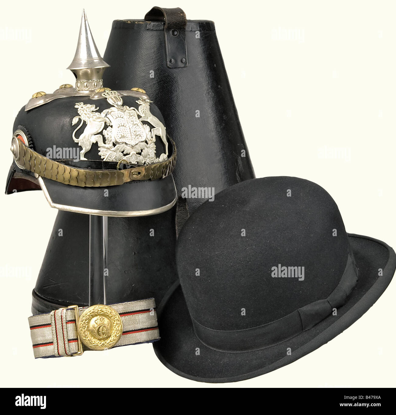 A helmet, waist belt and bowler hat, for a Captain of the Grenadier Regiment Queen Olga (1st Württemberg), No. 119 Stuttgart. An officer's helmet, with a black leather skull, silver mountings, a cross base with a small golden star, silvered, frosted front-plate with partially polished edges. Flat golden metal chinscales. Angular, silver trimmed visor, both cockades. Ribbed silk lining loose in places. Size 57. An officer's waist belt, silver weave with two black/red interweavings. Complete with buckle and slides. Length, ca. 95 cm. A black bowler hat in first c, Stock Photo