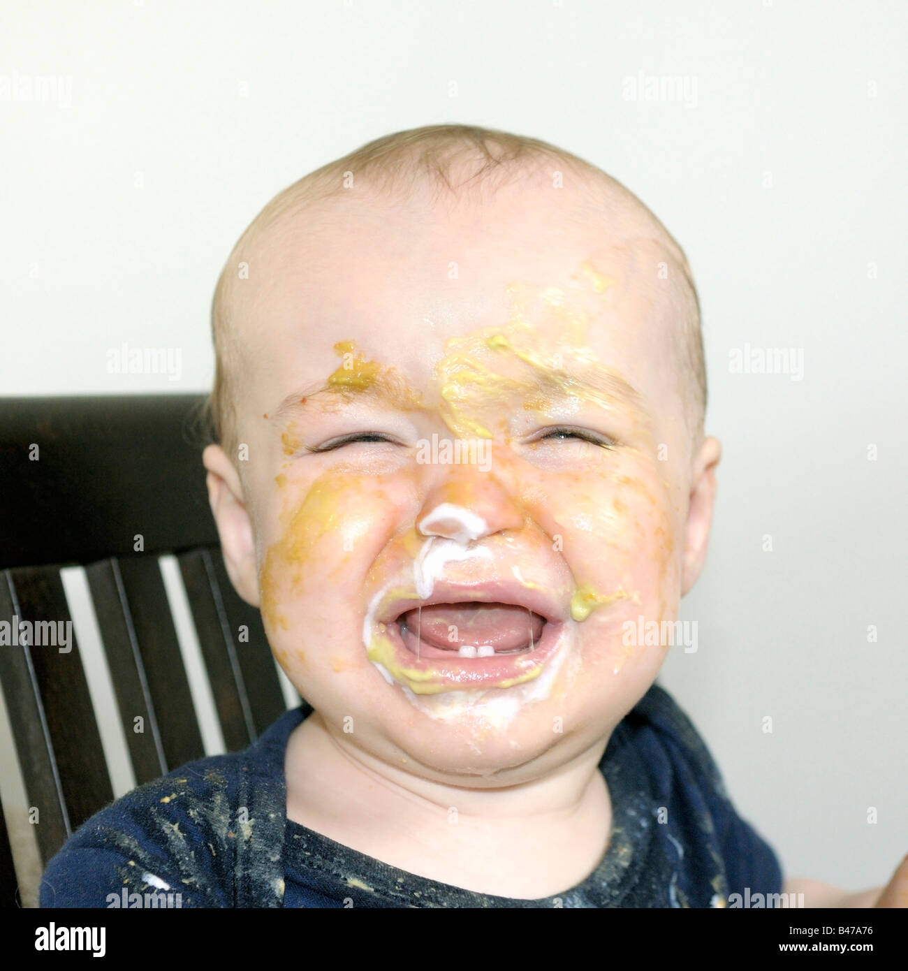 A ten month old baby boy at mealtime Stock Photo Alamy
