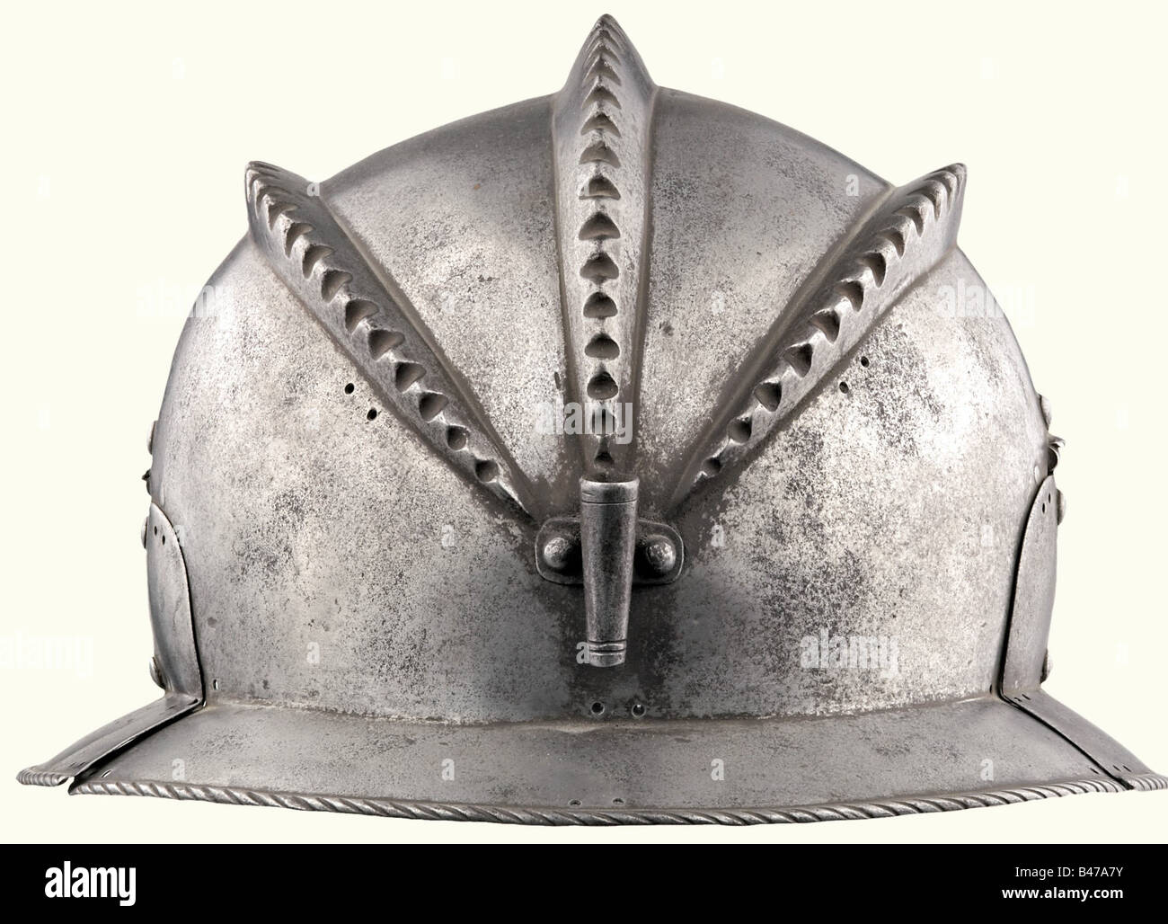 A burgonet with three combs, Augsburg, circa 1540/50 Skull forged in one piece with three low, serrated combs. There is a plume socket riveted at the nape and hinged cheek pieces on the sides. A short, slightly angled brim with a turned under corded rim. Numerous double holes for fastening the fabric helmet covering. The Augsburg acceptance mark (pine cone) is stamped on the front of the brim next to the arsenal mark of the Vienna Armory. Height 17.5 cm. Light burgonet that was originally provided with a velvet cloth covering. Kaiser Karl V wears a similar helm, Stock Photo