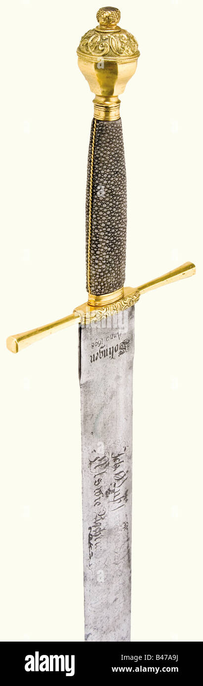 An executioner's sword, Solingen, dated 1698 Flat, double-edged blade with a blunt, lightly rounded point. The lower third is somewhat pitted. There is an etched saying on one side, 'Ich Muß straffen daß verbrechen - Als wie Recht und Richter sprechen.' (I have to punish crime as the law and judge tell me.) On the opposite side there is a city coat of arms with laurel and oak branches, probably a later etching from around 1850. 'Solingen Anno 1698' is inscribed on the ricasso, with a copper mark and the monogram 'RL' on the other side, separated by an orb. Fire, Stock Photo