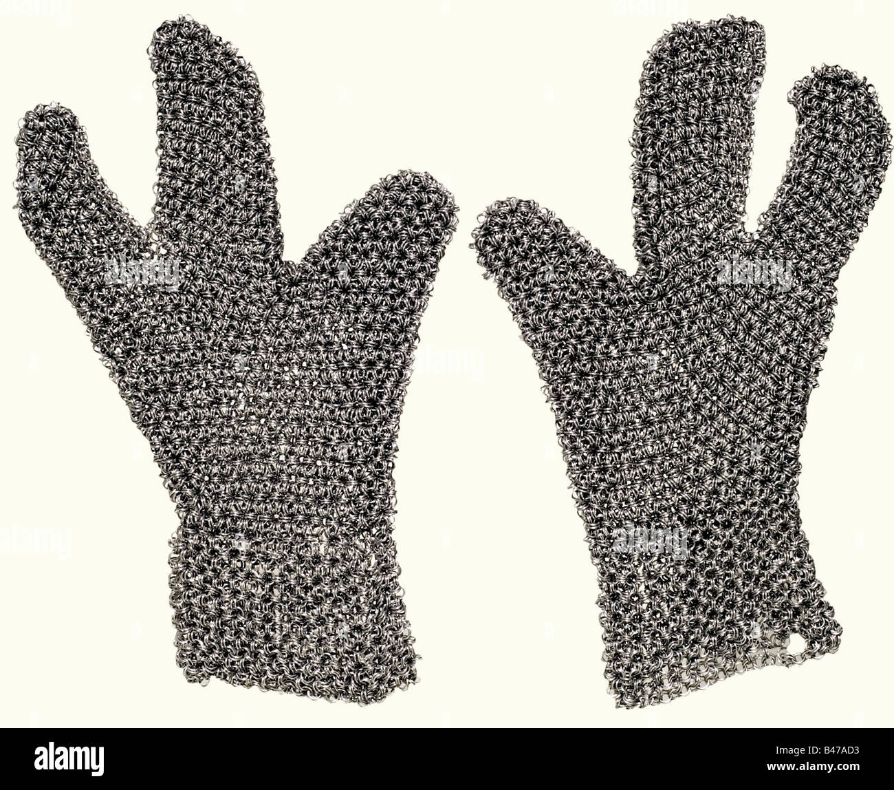 A set of chain mail, Southern Caucasus, 1st half of the 19th century. Hauberk, coif, and gloves, made of mail of different strengths. The rings are not riveted, and in the oriental fashion are always hung on six sides of a central double ring. Short shirt with long sleeves of extremely heavy mail. The interior of the sleeve has been lightly worked. The lower edge is scalloped. Isolated defects. The coif has a heavy calotte and lighter sides and collar. Three-fingered gloves. Length of the hauberk, ca. 68 cm. Extremely high quality workmanship on the hauberk, wh, Stock Photo