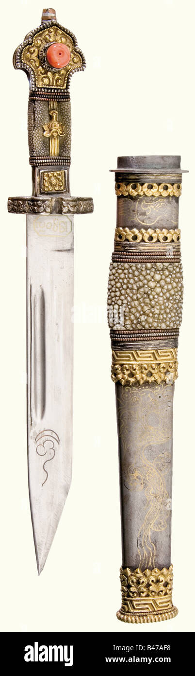 A silver-mounted dughti, Tibet, circa 1900 A blade with fullers on both sides and brass and copper-inlaid marks on the obverse side. The silver-mounted and partially gilded grip is embossed with floral designs. Rayskin grip cover, set with coral on the obverse side. The iron scabbard is decorated with brass-inlaid dragons, rayskin, and gilded silver mountings, and a chiselled iron bar with a suspension ring on the reverse side. Beautiful quality. Length 36.5 cm. historic, historical, 1900s, 20th century, 19th century, Far East, Far Eastern, weapon, arms, weapon, Stock Photo