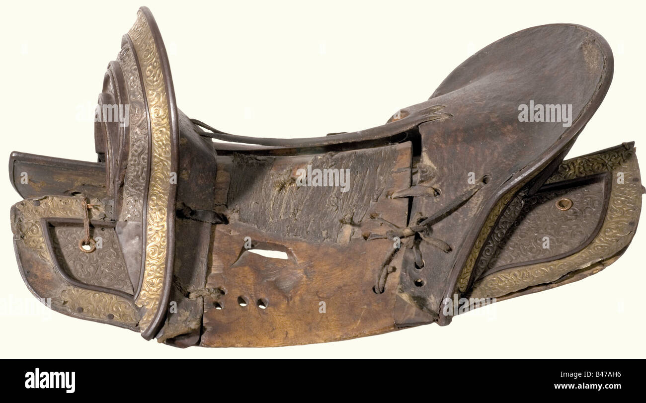 A magnificent saddle, Tibet, 19th century Partially leather covered wooden construction, both cantle and saddletree are mounted with fine relief decoration in silver and brass, a little loose at the left edge. All pieces are tied together with straps and reins. Length 55 cm. historic, historical, 19th century, Far East, Far Eastern, weapon, arms, weapons, arms, military, militaria, clipping, cut out, cut-out, cut-outs, object, objects, stills, Stock Photo