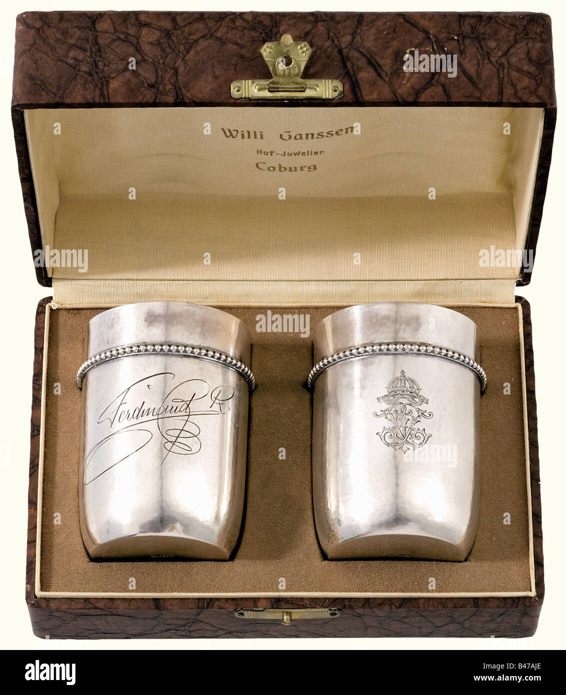 Tsar Ferdinand I of Bulgaria (1861 - 1948), a pair of silver presentation bowls in a case Hand hammered bowls with gold plated interiors and friezes of bead moulding under the lip of the rims. On the front of each the engraved cipher beneath the Bulgarian crown, and on the reverse side, one bowl has the engraved signature 'Ferdinand R.' the other has an illegible signature. German hallmark '800' next to the crescent moon and crown along with the number '33' on the bottom. Height of each 75 mm. Weights 68 and 70 grams. In a case with a crowned cipher superimpose, Stock Photo