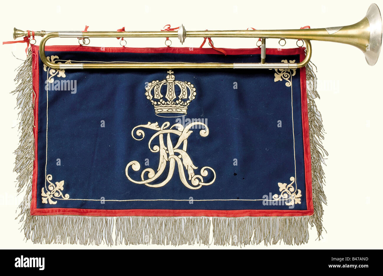 A trumpet with pennant, of the Grenadier-Regiment König Karl (5. Württembergisches) No. 123 Brass trumpet with nickel fittings produced by Reisser in Ulm. Length 80 cm. Dark blue cloth embroidered on both sides with the white-blue cipher 'KR' beneath a crown. Red trim on the edge and silver fringe on three sides. 60 x 38 cm. historic, historical, 19th century, Wuerttemberg, Wurttemberg, Württemberg, Southern Germany, the South of Germany, south german, object, objects, stills, clipping, clippings, cut out, cut-out, cut-outs, insignia, symbols, symbol, emblem, e, Stock Photo