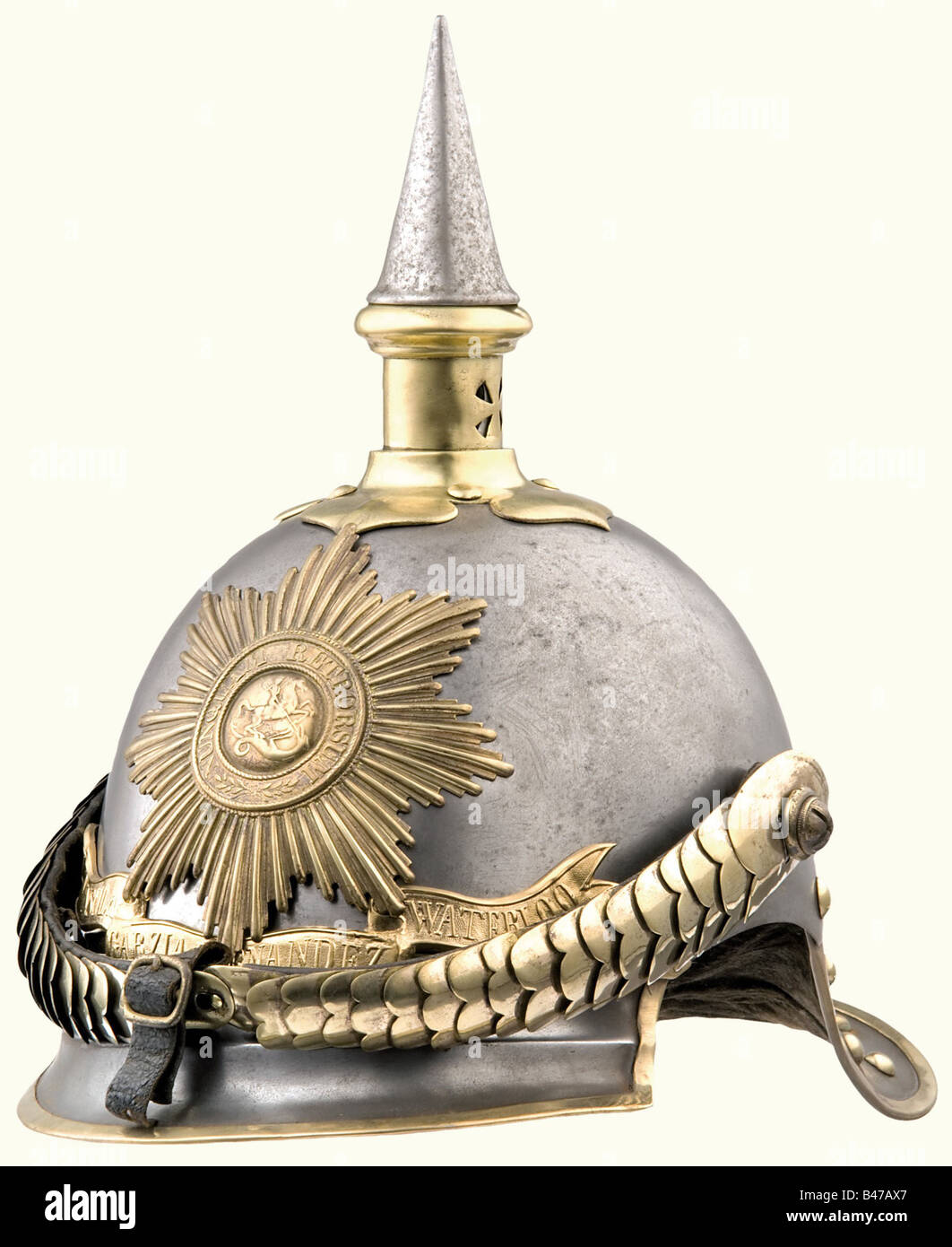 A model 1862 helmet for enlisted personnel, of the Garde du Corps Regiment. Steel skull with brass mountings, ridged front peak. Brass fittings. Star of the Order of St. George, with the scroll beneath it reading, 'Peninsula-Garzia Hernandez-Waterloo'. Convex metal chinstraps. Skull has a matt coating of rust. Scroll a replacement. The rosettes for the chinstrap, cockades and lining are missing. Damaged velvet lining for the rear peak. historic, historical, 19th century, object, objects, stills, clipping, clippings, cut out, cut-out, cut-outs, helmet, helmets, , Stock Photo