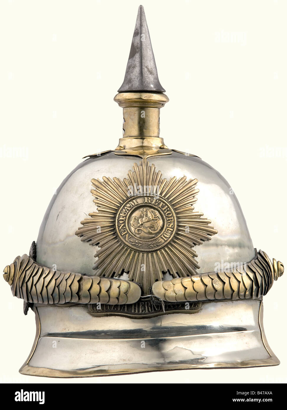 A model 1862 helmet for enlisted personnel, of the Garde du Corps Regiment. A German silver skull with brass mountings. Ridged front peak, brass fittings. Star of the Order of St. George, with the scroll under it reading, 'Peninsula-Garzia Hernandez-Waterloo'. Convex metal chinstrap, on cross slotted screws. Stamped leather cockade. Skull has repaired damage on the back. Lining missing. historic, historical, 19th century, object, objects, stills, clipping, clippings, cut out, cut-out, cut-outs, helmet, helmets, headpiece, headpieces, utensil, piece of equipment, Stock Photo
