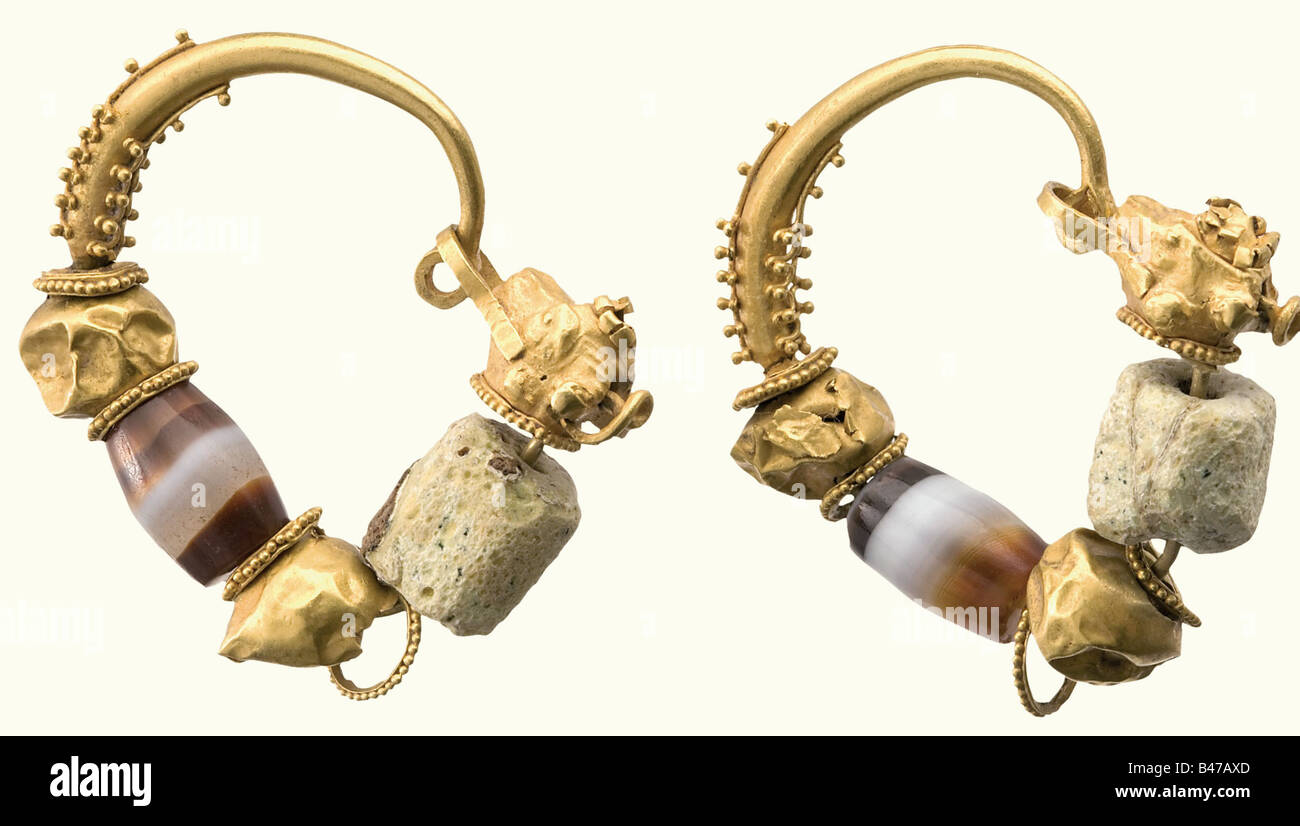 A pair of golden rams head earrings, Hellenic, 4th/3rd century B.C. Hollow worked hoops with granular ornamentation and hanging rosettes, hollow balls, and an agate and glass bead. The latches are hollow worked rams heads. The hollow balls are deformed or damaged. Height of each 3.2 cm. Weight 10.5 grams. historic, historical, ancient world, ancient world, ancient times, object, objects, stills, clipping, cut out, cut-out, cut-outs, jewellery, jewelry, Stock Photo