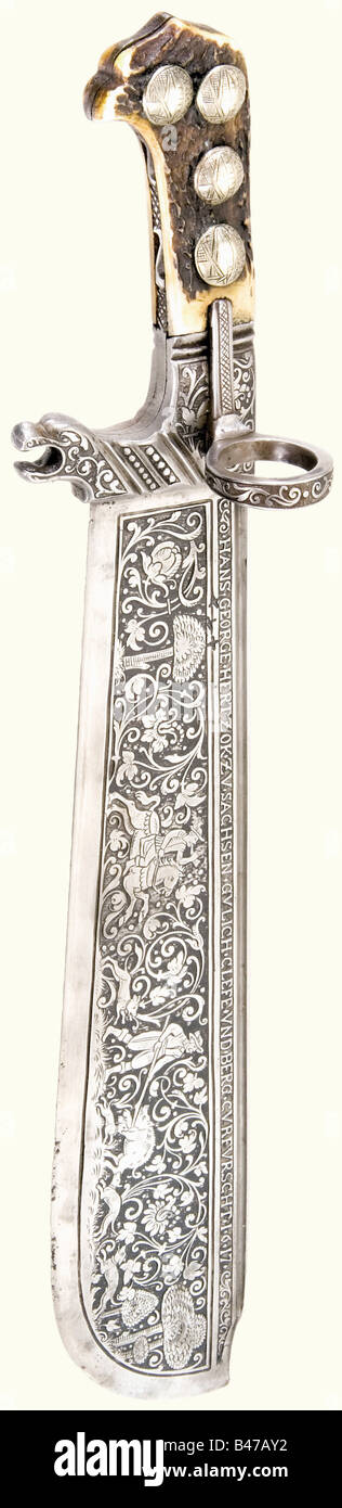 A magnificent chiselled 'Waidpraxe' (hunting cutlass), Saxon, dated 1617 A heavy blade with fullers on both sides and the entire obverse side chiselled with a hunting scene and floral vines. Three cross-shaped marks. Inscribed, 'HANS GEORGE HERTZOK ZU SACHSEN GULICH CLEFE UND BERG CURFURSCHT 1617' along the back and the Saxon coat of arms on the reverse side. Quillons with chiselled floral decoration, a thumb ring, and a monster head on the side. Staghorn grip scales. The four brass rivets on the obverse side are engraved with the Saxon coat of arms. Fine quali, Stock Photo