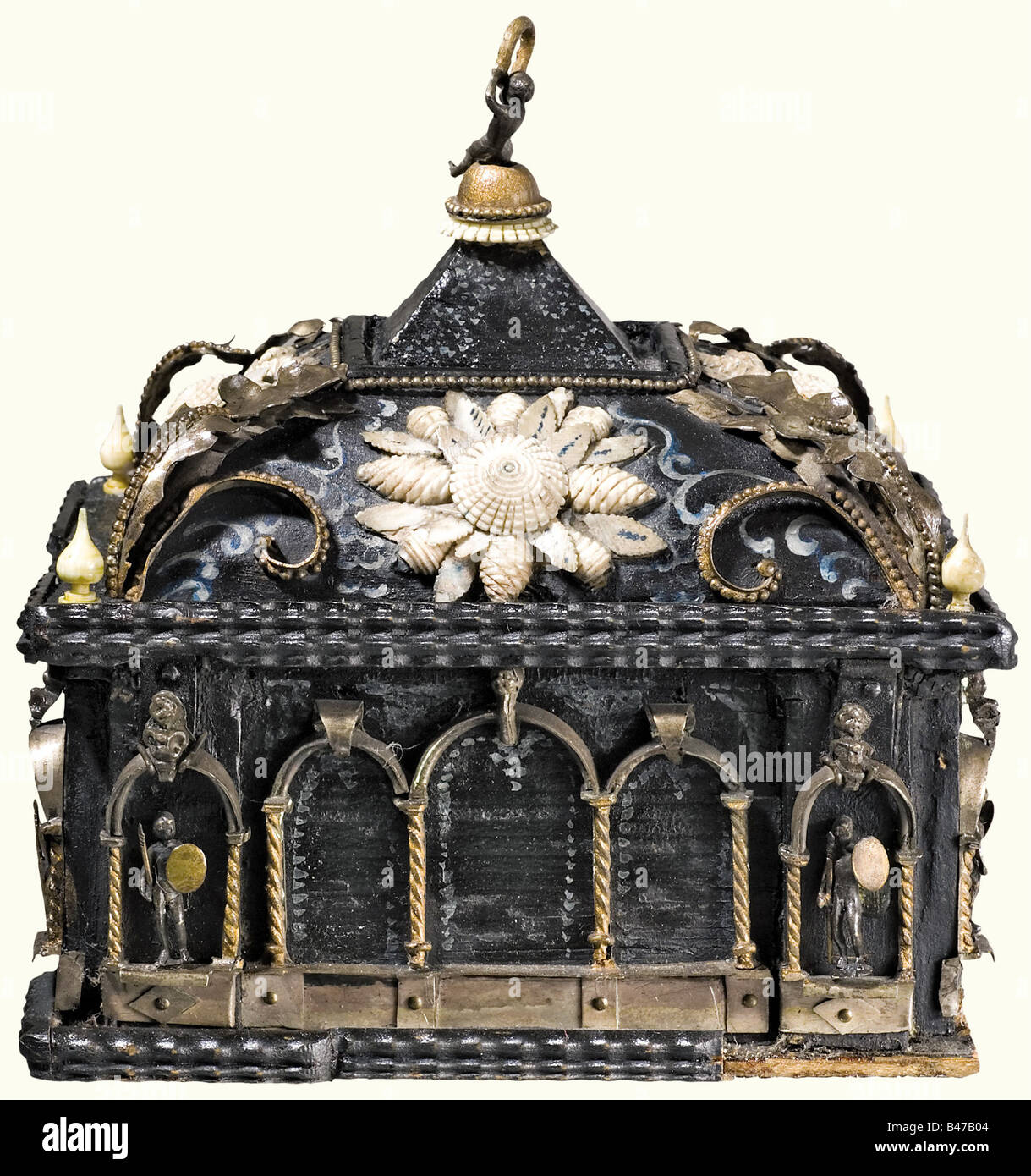 A splendid casket, German or Italian, 2nd half of the 17th century Casket of dark painted wood richly mounted with decorative brass, and bone fittings. Rectangular body with rounded corners and flamed edging. Surrounded with superimposed brass arcades in fine relief. Two figures set on each side: two crossbowmen on the front and warriors with spear and shield on the sides and in back. There are finely tuned columns of bone on the front edges. Cambered lid decorated with finely carved bone, with brass Ornaments on the edges. There is a pyramid shaped mounting on, Stock Photo