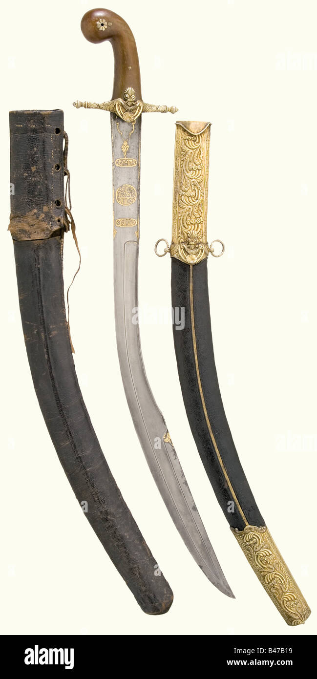 A kilij with gold-plated silver mountings, Ottoman, circa 1800 A heavy blade of watered steel with a chiselled back and a broadened double-edged point. Gold-inlaid inscription cartouches on both sides at the base of the blade. The quillons are deeply chiselled in relief. Two large rhinoceros horn grip scales. Shagreen leather covered wooden scabbard with furniture embossed en suite. Splendid sabre in beautiful condition. Length 92 cm. In addition the original leather transport case with decorative embroidery on the obverse side, opening above the carrying rings, Stock Photo
