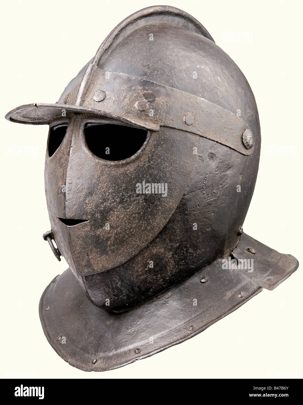 A Savoyard helmet (burgonet), or Italian, circa 1620 Heavy, hammered made of two pieces with a narrow comb, riveted neck protector and plume socket the back. Typical death's-head visor
