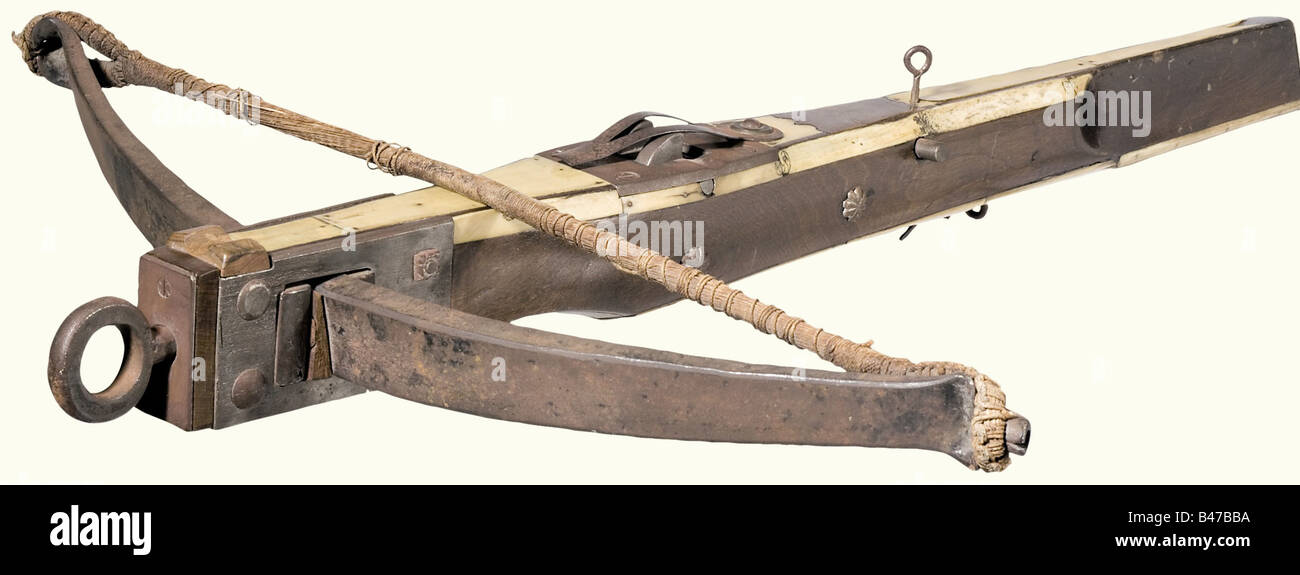 A sporting crossbow, German, 19th century, using old parts Heavy, forged iron prod with a twisted bowstring. Screw mounted iron bridle with a foot ring. Slender, bellied, wooden tiller with an indicated cheekpiece and partial decorative bone stripes. Screw mounted iron nut. Set trigger and a quarrel retainer. Length 80 cm. historic, historical, 19th century, crossbow, crossbows, distance weapon, weapons, object, objects, clipping, cut out, cut-out, cut-outs, Stock Photo