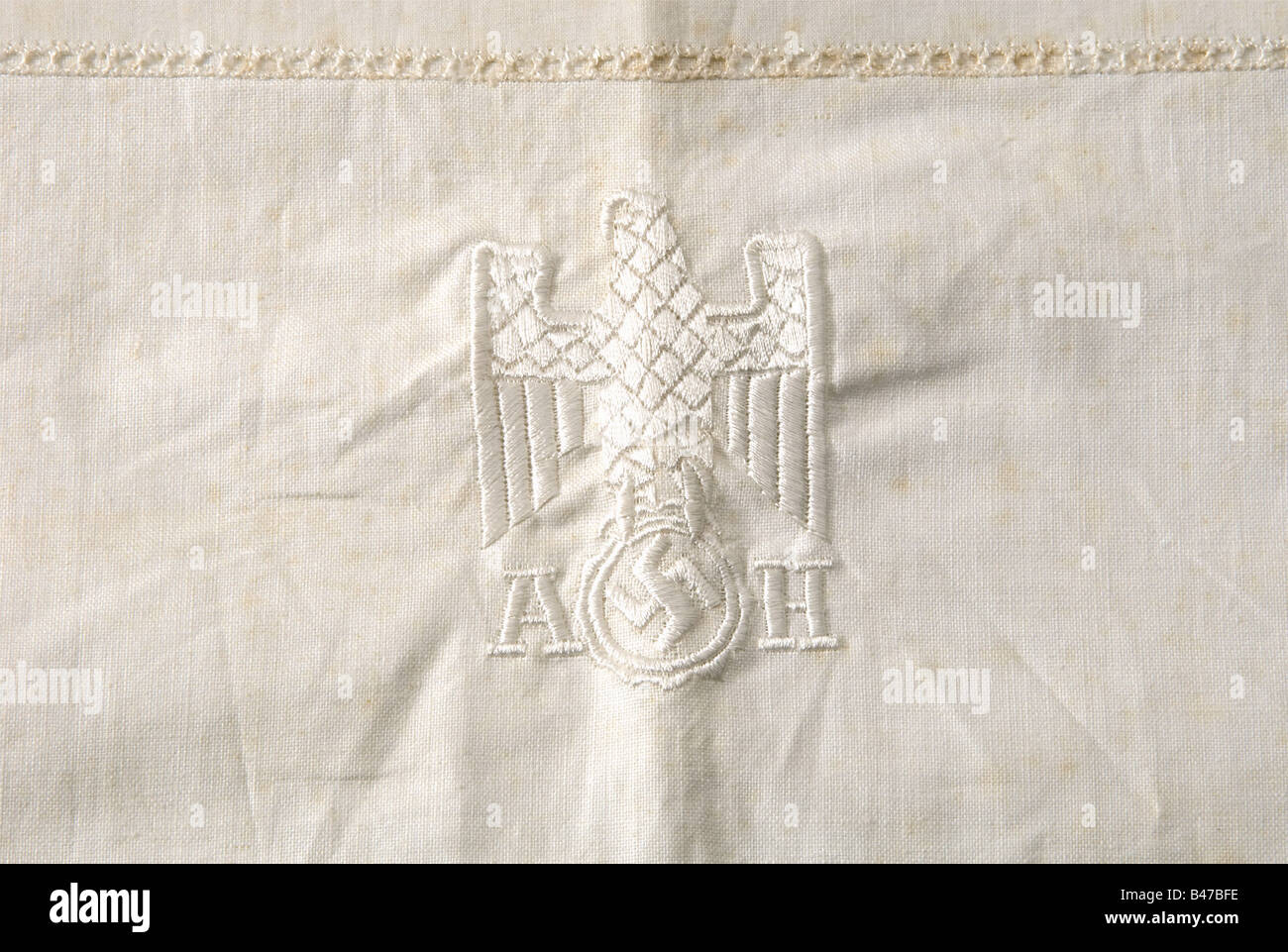 Adolf Hitler, his personal bedclothes Pillow case and duvet cover of light white linen with restrained, silk embroidered, floral decoration and geometric trim on the pillow. The party eagle is embroidered in white silk in the centre of each, flanked by the initials 'A' and 'H'. Ca. 75 x 75 and 120 x 175 cm respectively. Undamaged, (mould-)stained in places. historic, historical, 1930s, 1930s, 20th century, NS, National Socialism, Nazism, Third Reich, German Reich, Germany, German, National Socialist, Nazi, Nazi period, fascism, fine arts, art, art object, art o, Stock Photo