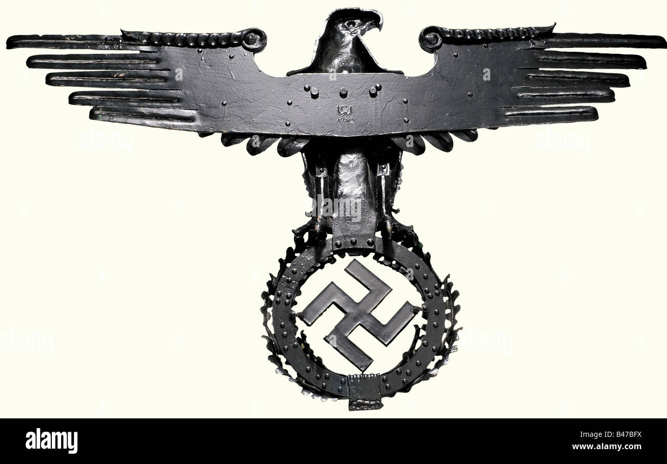 A wrought iron national eagle, for a building of the Wehrmacht Forged in several parts, bolted and riveted. On the back the smith's monogram 'C W' above '1940'. Due to the special artistic forging technique a three dimensional vivid impression is created. Height 98 cm, Wing span 158 cm. Renovated blackening. Probably a work of the castle forge Wewelsburg, which produced several artistically made national eagle emblems in the typical Wewelsburg style for SS and Wehrmacht barracks. Three wrought iron artisans from the school of handicraft in Dortmund originally w, Stock Photo