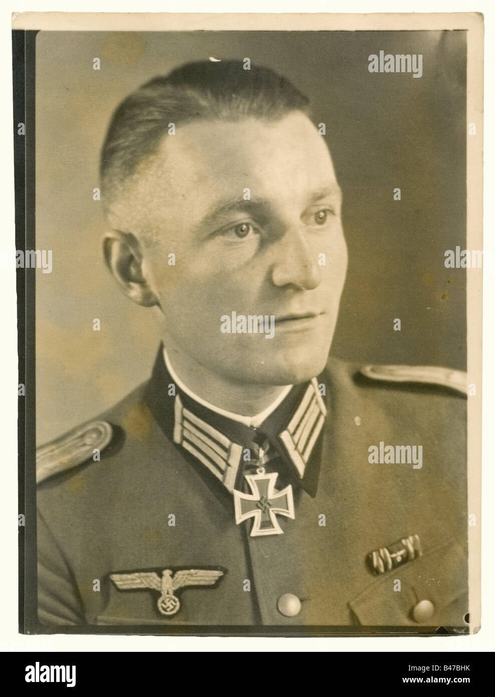 1st Lieutenant Wilhelm Cirener, documents and photographs Preliminary award document for the Knight's Cross of the Iron Cross on 13 July 1940 as company commander, 3rd/Pioneer Battalion 33. Original von Brauchitsch signature, folded, small pressure marks. Included is a decorative sheet with best wishes from Colonel Bölckers, commanding Infantry Regiment 115. Included are documents for Service Award, 4th Class (torn, damaged) 31 October 1938, possession certificate for General Assault Badge 15 October 1940 with original signature Generalmajor Kühn, duty pass 1 A, Stock Photo