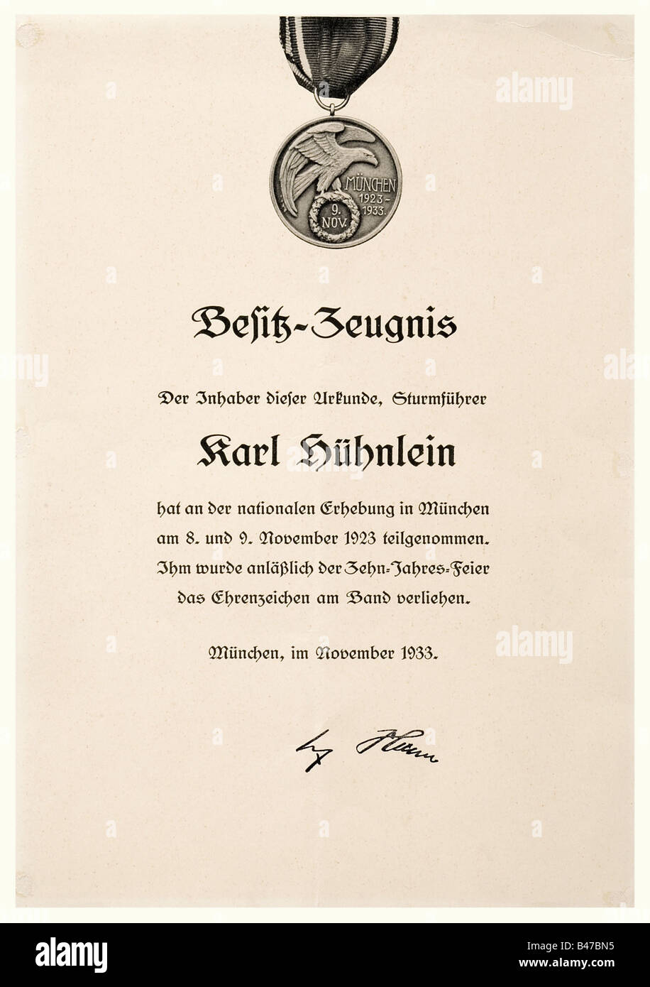 Ehrenzeichen vom 8./9. November 1923 (Blood Order), award document, 1st type, 1933 Monochrome printed, single-sided award certificate on thin, yellowish cardboard, 22.2 x 31.7 cm, at the top is a photographic depiction of the medal awarded to Karl Hühnlein (registration number 407), dated November 1933, facsimile signature of Hitler in lower portion. Small warp, traces of glue from a former mounting. Included is an award certificate for the Cross of Honour for Front Fighters, 1935. Karl Hühnlein (b. 10 May 1900), nephew of the NSKK leader Adolf Hühnlein, was a , Stock Photo