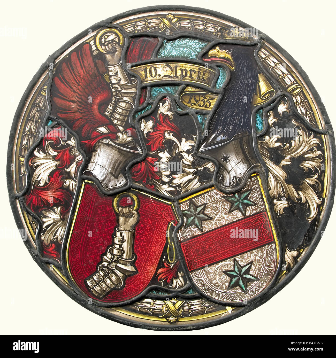 Hermann Göring and Emmy Sonnemann, a stained glass coat of arms A gift from Adolf Hitler to Hermann Göring and Emmy Sonnemann on the occasion of their wedding on 10 April 1935. Very fine coloured painting of the marriage coat of arms of the wedding pair, the shield of Göring's arms is covered with small swastikas. The wedding date, "10. April 1935" between the two helmet plumes. The artist's signature, "C. Busch" is at the lower right. Two small flaws. Diameter 38 cm. Enclosed is a notarially certified declaration by K. Frank Korf, soldier with the US 3rd Army,, Stock Photo