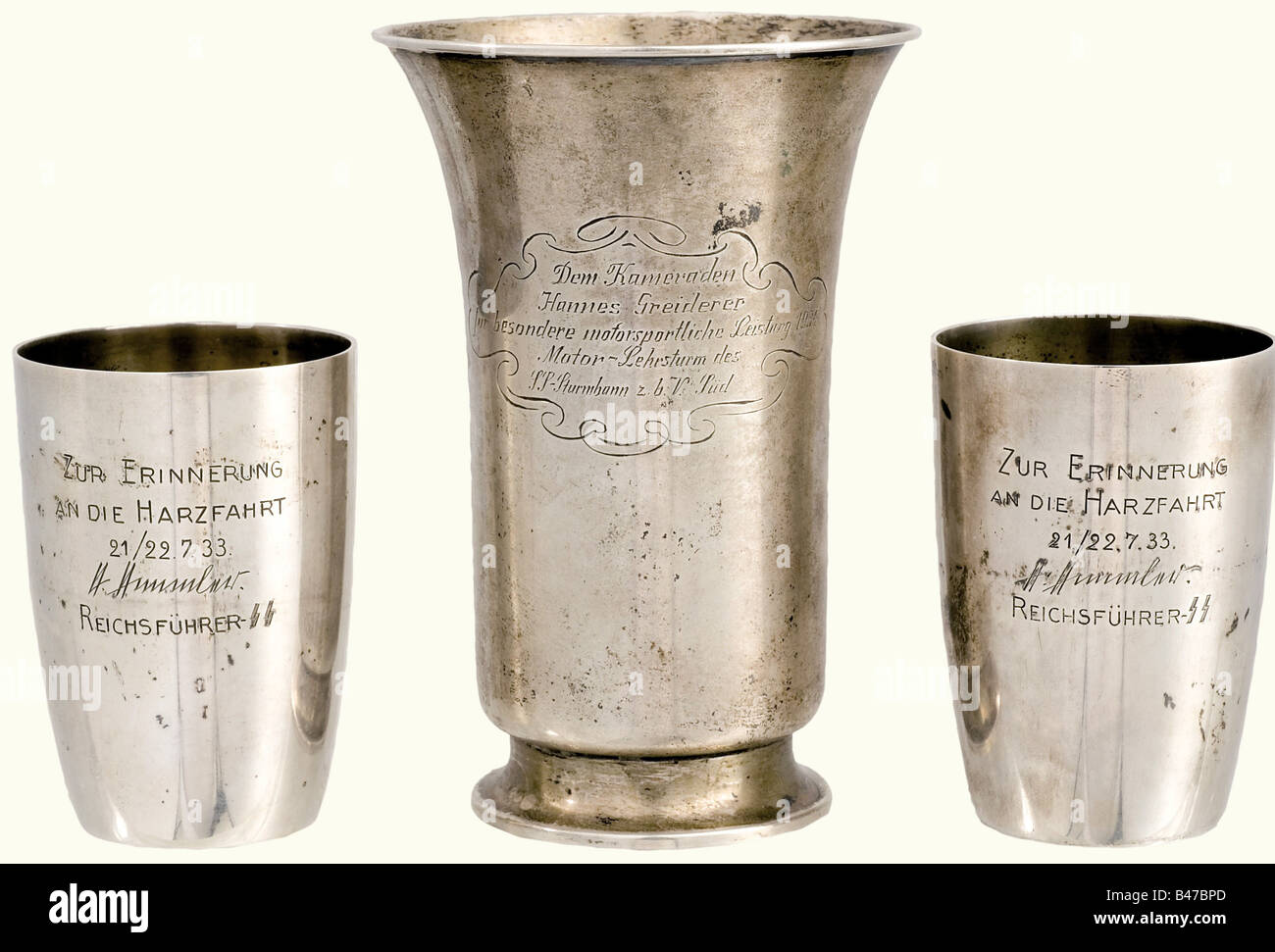 SS-Obersturmführer Hannes Greiderer, two silver presentation beakers 1933 from Heinrich Himmler and a 1934 presentation beaker from the Gahr workshop. Identical beakers with gilt interior surfaces, the viewing surfaces engraved (transl.) 'In remembrance of the Harz (Mountains) trip 21 - 22 July, 1933 - Heinrich Himmler - Reichsführer SS'. At the bottoms mark of fineness '835' and number '63725'. Height of each 78 mm. Weights 73 and 76 g. The third beaker is engraved on the viewing surface with the dedication (transl.) 'To comrade Hannes Greiderer for especial m, Stock Photo