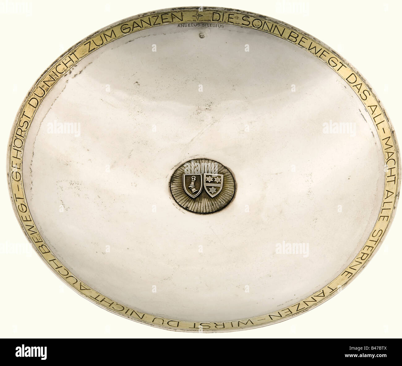 Hermann Göring and Emmy Sonnemann, a silver presentation bowl A shallow silver bowl with gilded rim, bearing a quotation from Angelus Silesius 'Die Sonne bewegt das All - Macht alle Sterne tanzen - Wirst du nicht auch bewegt - Gehörst du nicht zum Ganzen' (the sun moves everything - makes all the stars dance - if you're not moved - you don't belong to anything). In the centre there is a gilded sun with the coats of arms of Hermann Göring and his wife Emmy Sonnemann. The silversmith's mark of Professor Herbert Zeitner is in the 12 o'clock position. Marked, 'Zeit, Stock Photo