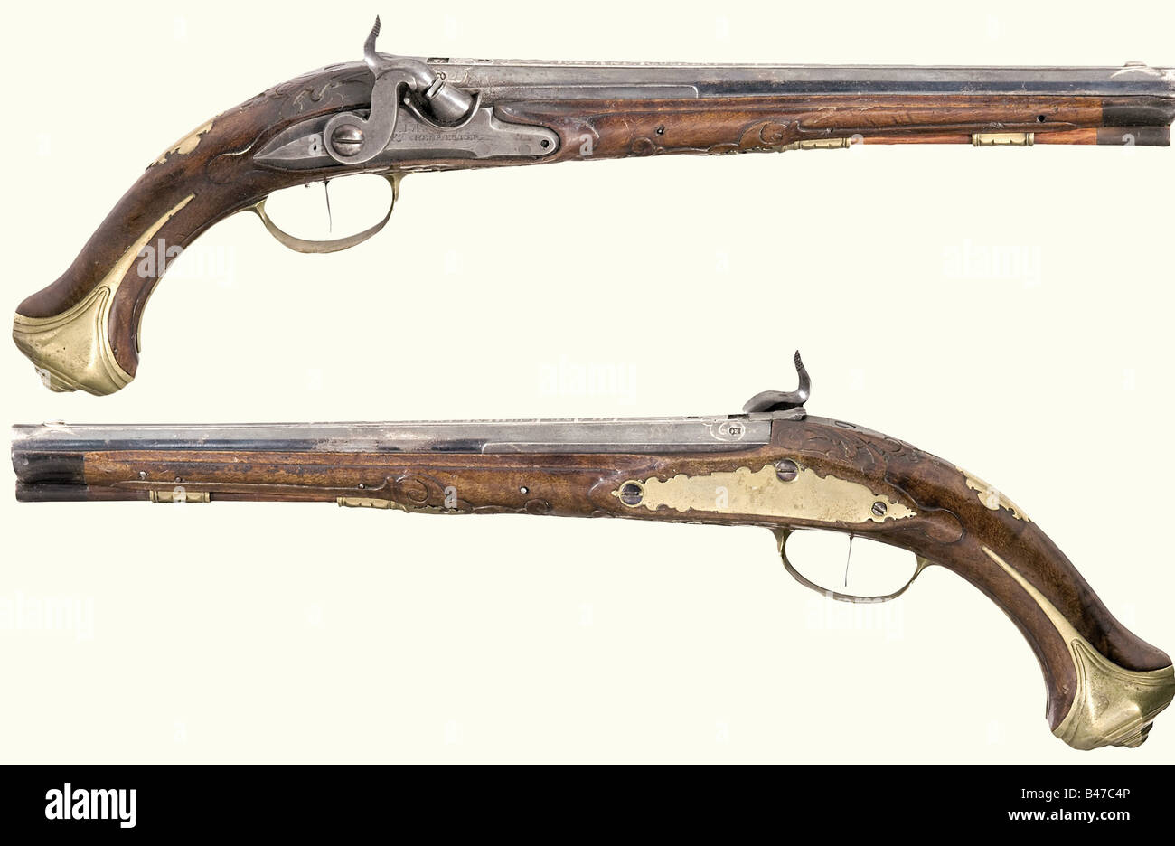A pair of percussion pistols, Johann Andreas Kuchenreuter, Steinweg bei Regensburg, circa 1780. Blued, smooth bore barrels in 12 mm calibre. Silver front sights and a silver-inlaid signature on the sighting flats. There are four silver-filled marks between inlaid scroll decorations on each of the breeches. The tangs are inscribed '1' and '2'. Converted locks with engraved signature. Set triggers. Lightly carved walnut fullstocks. Blank brass escutcheons with the monogram 'AM' stamped above them. Smooth brass furniture. Original wooden ramrods with horn tips. Le, Stock Photo
