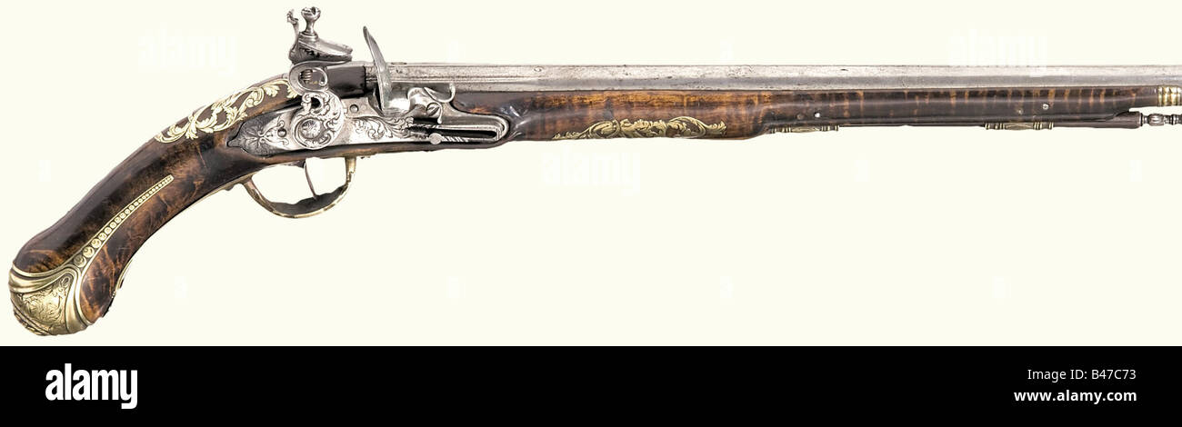 An Italian flintlock pistol, end of the 17th century. Round, long barrel with smooth bore in 12 mm calibre with brass filled marks at the breech. Chiselled flintlock with floral engraving. Beautiful walnut stock with lavish and richly engraved open work brass inlays. Original wooden ramrod with chiselled iron tip. Length 50 cm. Unshortened, elegant pistol. historic, historical, 17th century, civil handgun, civil handguns, handheld, gun, guns, firearm, fire arm, firearms, fire arms, weapons, arms, weapon, arm, object, objects, stills, clipping, clippings, cut ou, Stock Photo