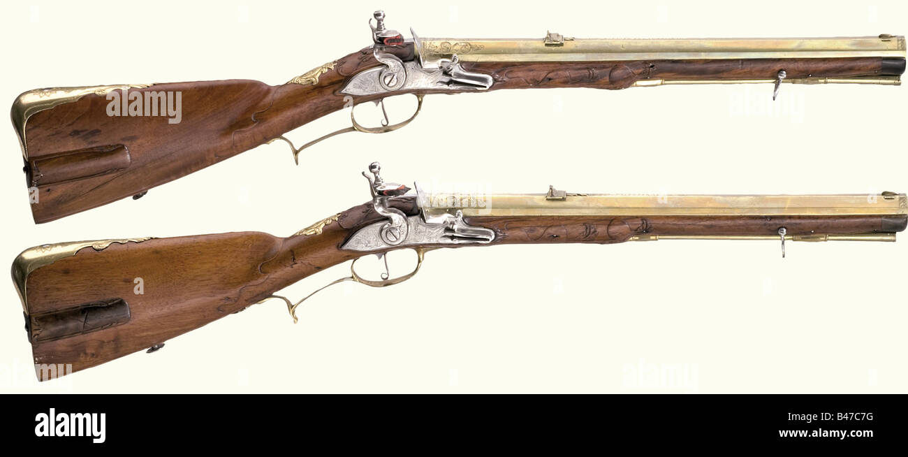 A pair of flintlock short rifles, I.C. Peter in Karlsbad, circa 1720. Heavy  octagonal barrels of gold-coloured bronze with seven groove rifled bores in  12 mm calibre. Dovetailed sights, one fixed rear