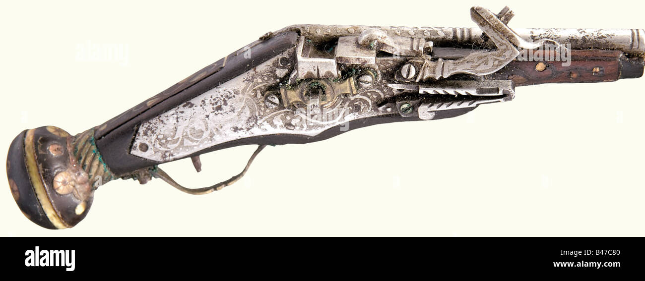 A miniature wheellock pistol, German, presumably 17th century. Octagonal barrel merging to round after a baluster with decorative etching on the front half. Etched lock, loose pan cover. Walnut stock with engraved bone inlays of jumping animals, leafy vines, flowers, and dots (almost completely preserved). Brass trigger guard and band. Lock function not tested. Length 100 mm. Beautiful miniature of an Augsburg wheellock pistol at the end of the 16th century. historic, historical, 17th century, civil handgun, civil handguns, handheld, gun, guns, firearm, fire ar, Stock Photo