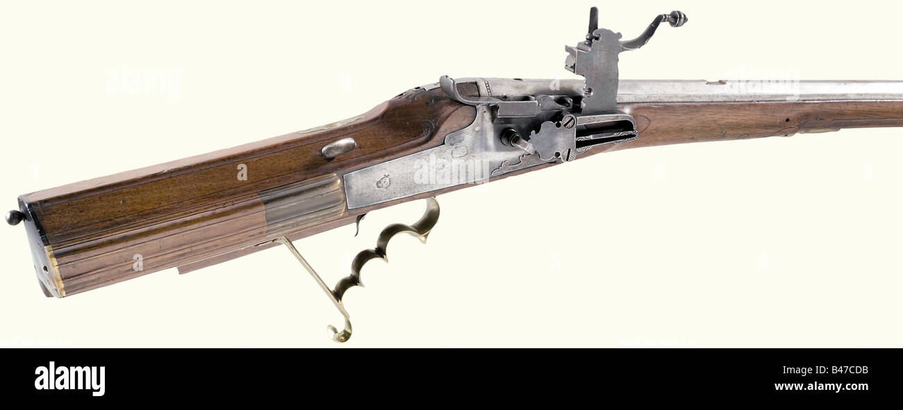 A wheellock rifle, German, circa 1720. Octagonal barrel with seven groove rifling in 12 mm calibre. Brass front sight and missing rear sight. A brass filled mark, 'IP' at the breech above a bird and an engraved '3'. Blued wheellock with an internal wheel and a set trigger (damaged, needle trigger shortened). The lockplate is inscribed 'IPM'. Carved walnut full stock (minimal crack on the forearm) with horn nosecap. Lead filled patchbox, and smooth brass furniture, Original wooden ramrod with horn tip. Length 114.5 cm. historic, historical, 18th century, civil l, Stock Photo