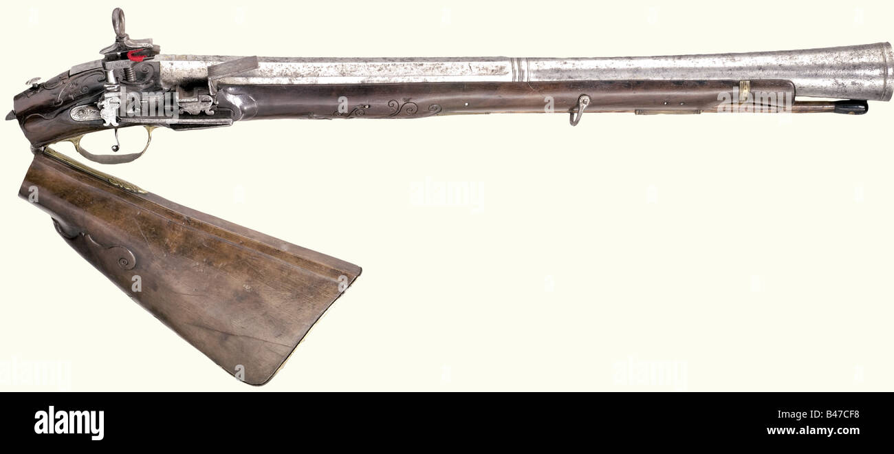 A blunderbuss with a miquelet lock, Naples, 2nd half of the 18th century. Octagonal barrel merging to round after a baluster, with a funnel shaped muzzle. There is an illegible brass filled mark on the top of the barrel. Miquelet lock with restrained engraving, signed 'Gaudio'. Carved folding stock with engraved brass furniture. Wooden ramrod, horn tip, and iron bullet puller. Length 92 cm. historic, historical, 18th century, civil long guns, gun, weapons, arms, weapon, arm, firearm, fire arm, gun, fire arms, firearms, guns, object, objects, stills, clipping, c, Stock Photo