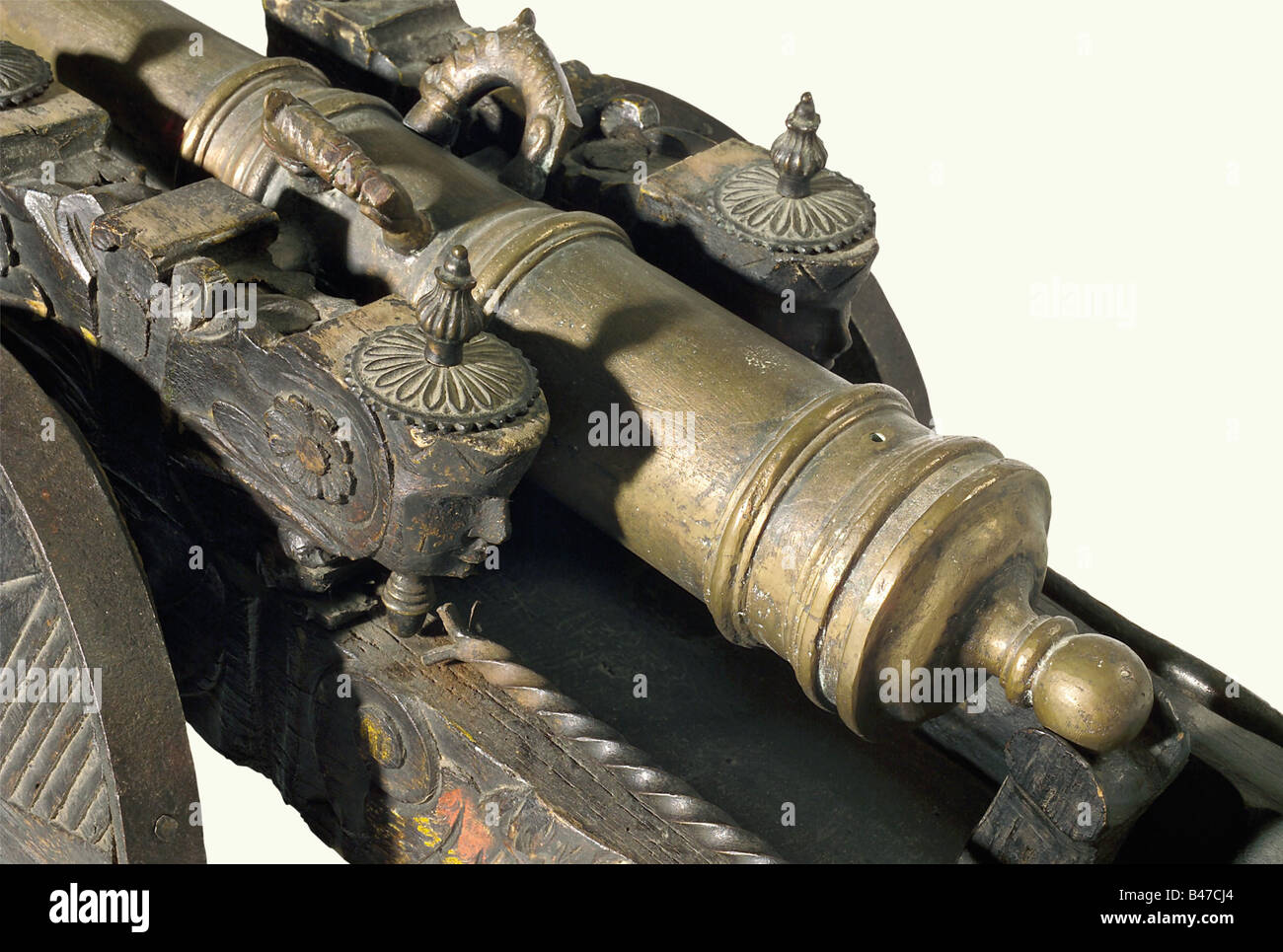 A model cannon, China, circa 1900. A heavy bronze barrel with a reinforced muzzle and breech. Touchhole on top with two dolphin-shaped handles. Barrel length 73 cm. Darkly finished, carved wooden carriage with iron furniture, full wooden wheels with star-shaped decoration, and iron loading tools. Total length 112 cm. historic, historical, 1900s, 20th century, 19th century, Far East, Far Eastern, weapon, arms, weapons, arms, military, militaria, clipping, cut out, cut-out, cut-outs, object, objects, stills, Stock Photo
