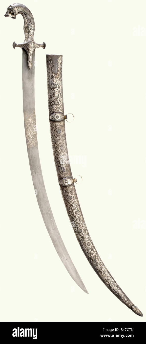 A silver-inlaid Indian tulwar, 19th century. Curved blade of welded ...