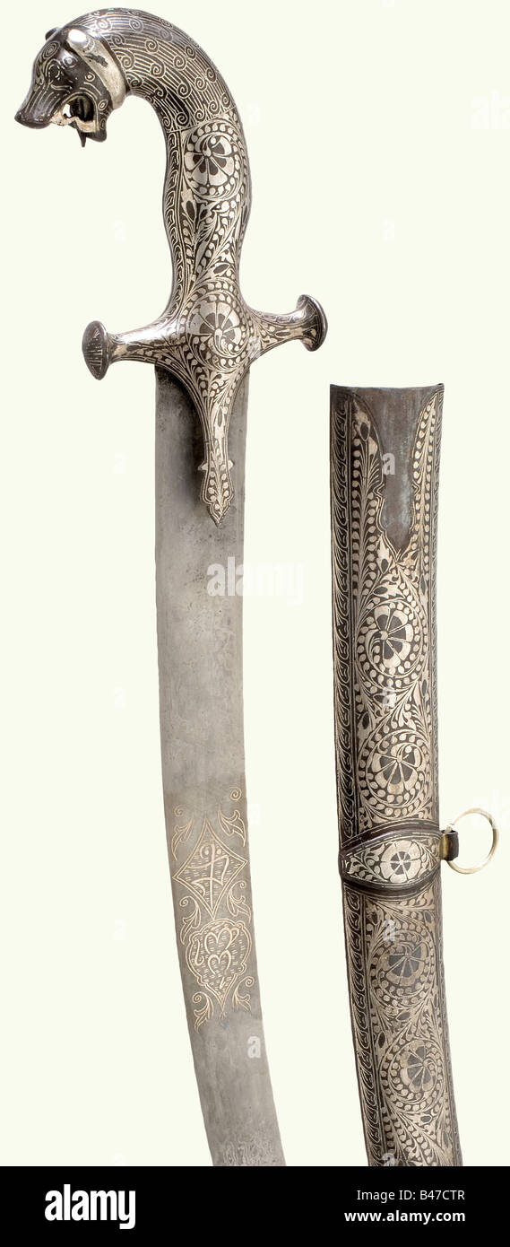 A silver-inlaid Indian tulwar, 19th century. Curved blade of welded ...